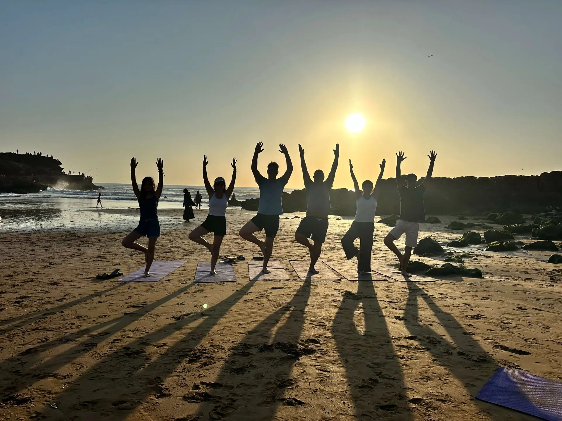 Outdoor yoga class at sunset near Agadir, Morocco